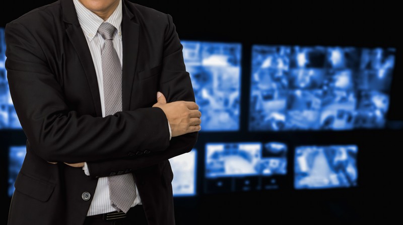 Young businessman on the background CCTV system.