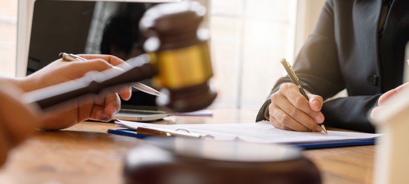 Cropped shot of business people and lawyer or judge team discussing signing contract, Concepts of law, advice, legal services.